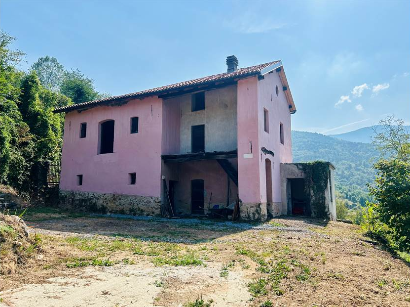 Farmhouse with land and private water source.