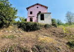 Farmhouse with land and private water source.