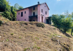 Farmhouse with land and private water source.