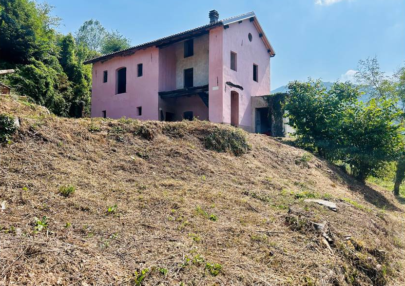Farmhouse with land and private water source.