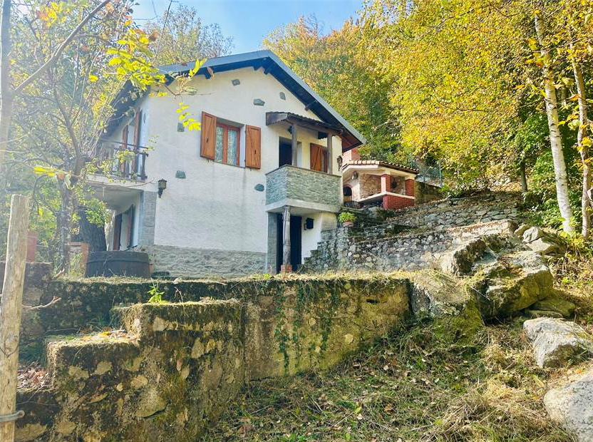 Detached villa with surrounding land.