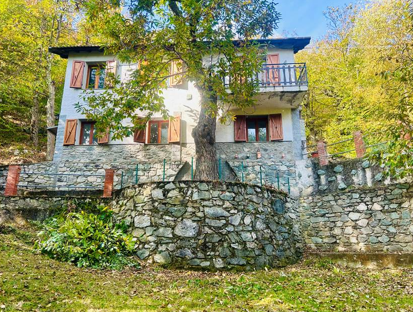 Detached villa with surrounding land.