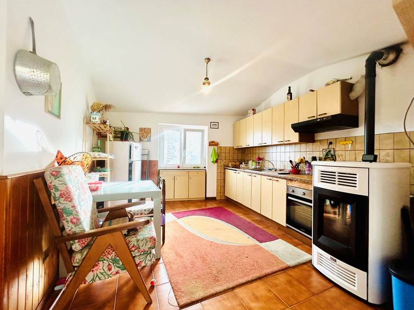 Portion of a house with a terrace overlooking the sea.