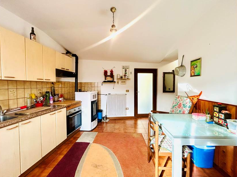 Portion of a house with a terrace overlooking the sea.