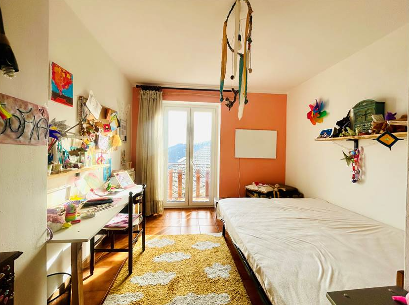 Portion of a house with a terrace overlooking the sea.