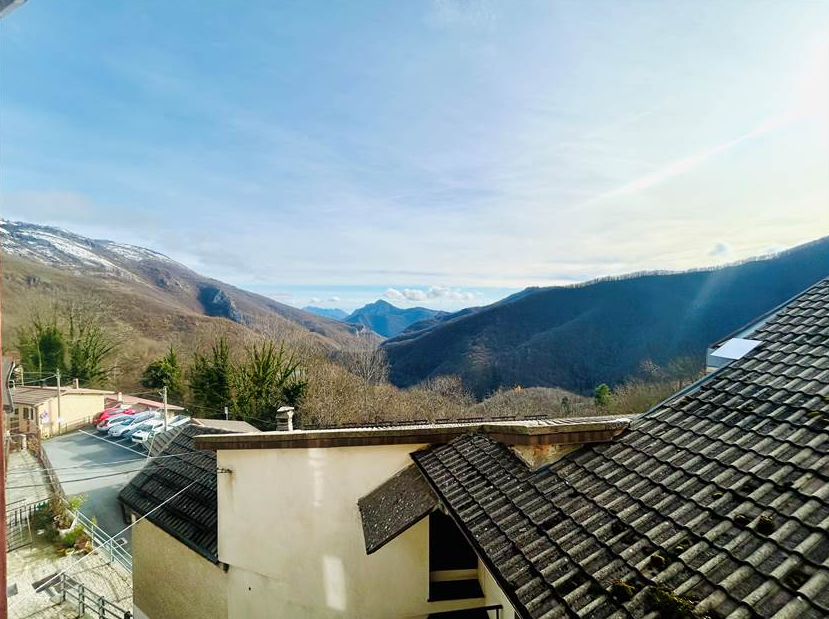 Portion of a house with a terrace overlooking the sea.