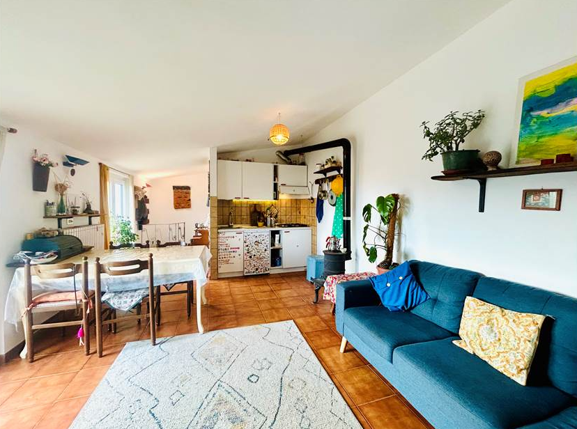 Portion of a house with a terrace overlooking the sea.