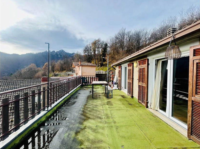 Portion of a house with a terrace overlooking the sea.