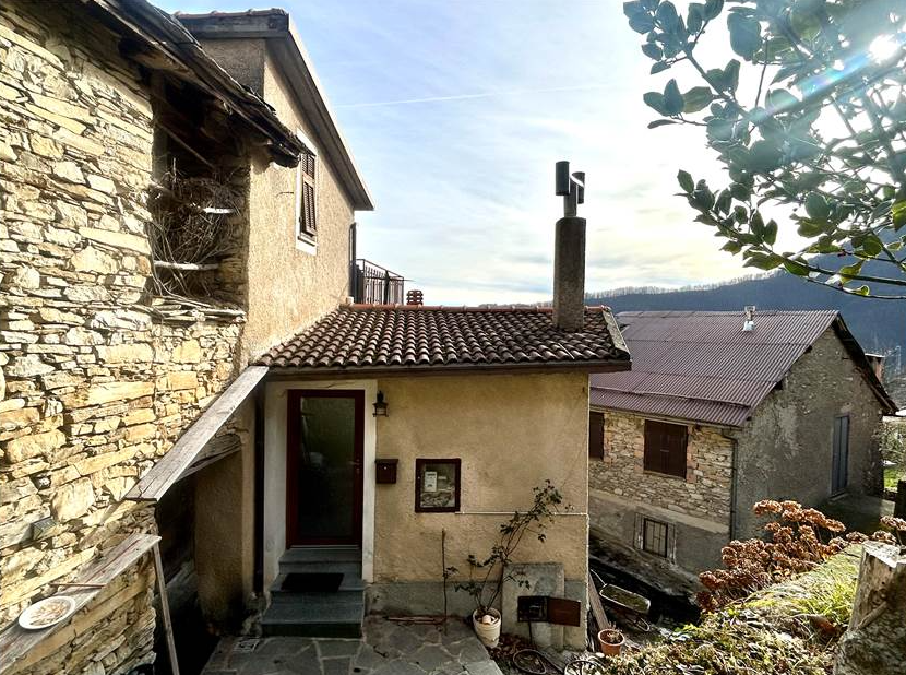 Portion of a house with a terrace overlooking the sea.